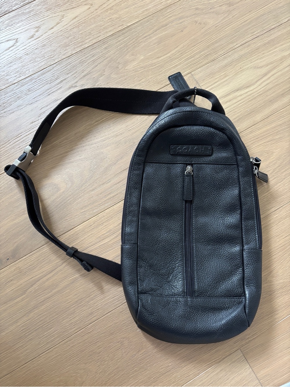 Coach pebbled black leather sling bag